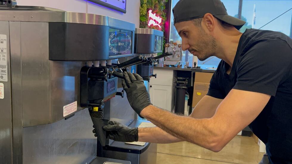 Owner Jonathan Behich is serving the Yuzu soft serve in black cones.
