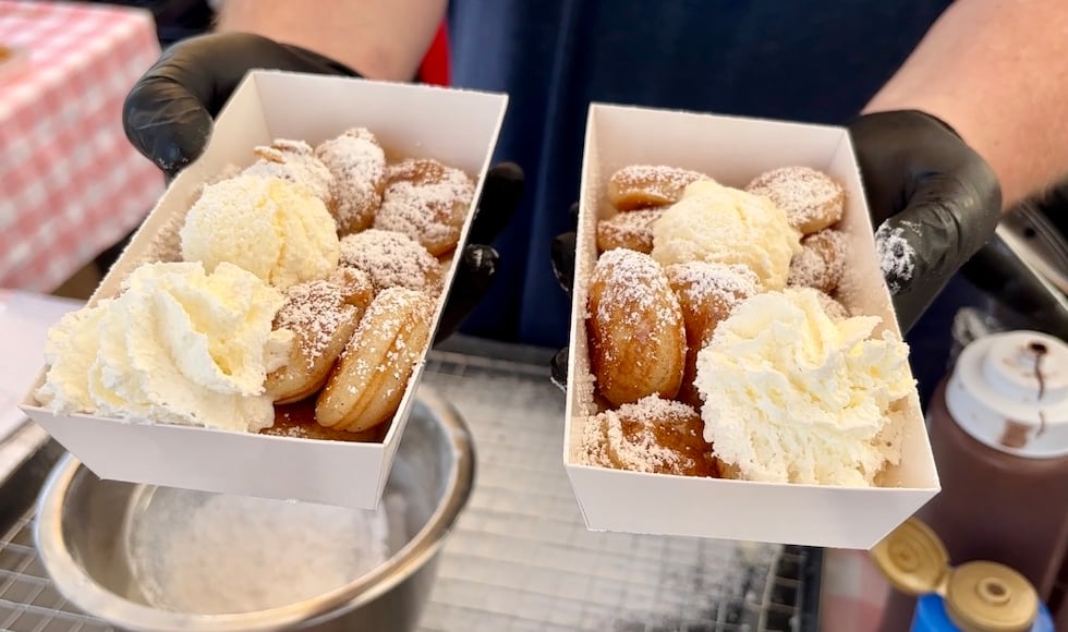 Poffcakes serves traditional Dutch poffertjes served with powdered sugar, butter, and whipped...