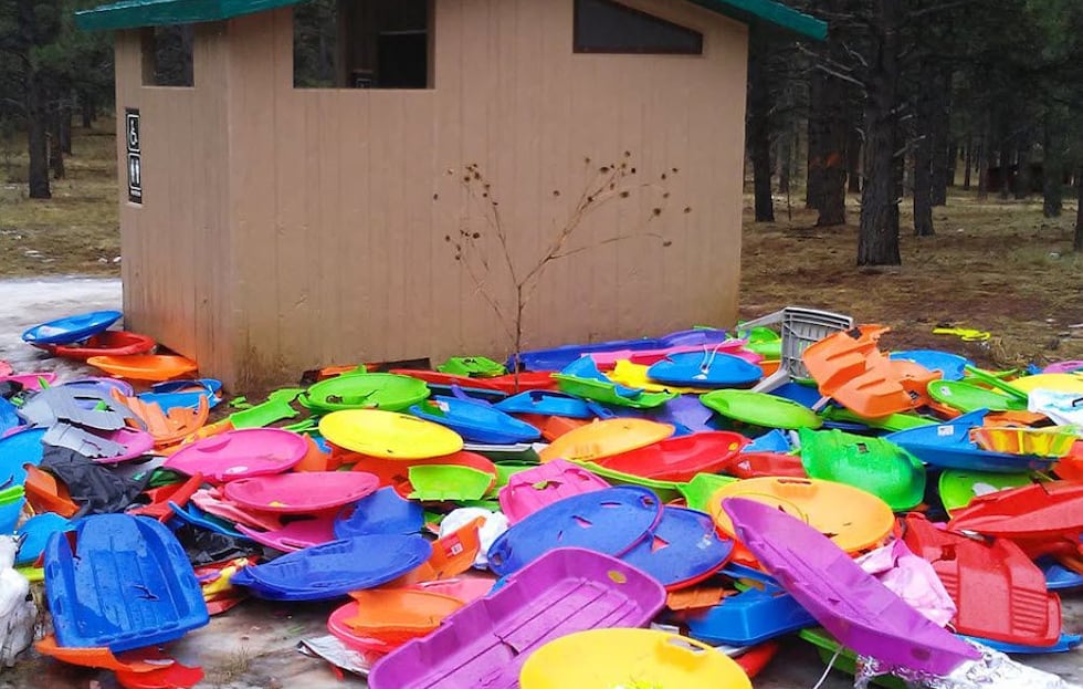 Trash includes broken sleds, deflated snow tubes and food waste