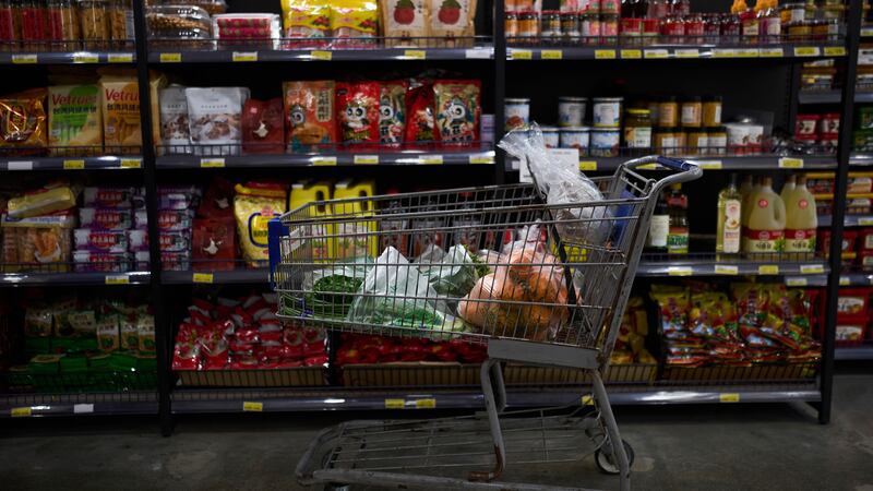 A shopping cart filled with groceries sits in an aisle at an Asian grocery store in Rowland...