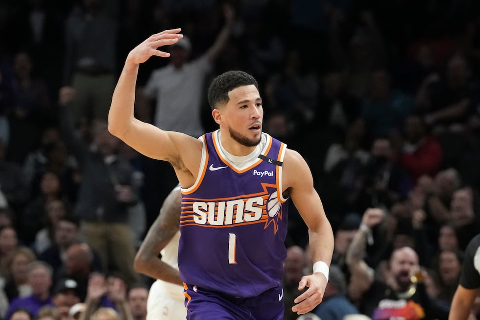 Phoenix Suns guard Devin Booker celebrates his 3-pointer against the Minnesota Timberwolves...