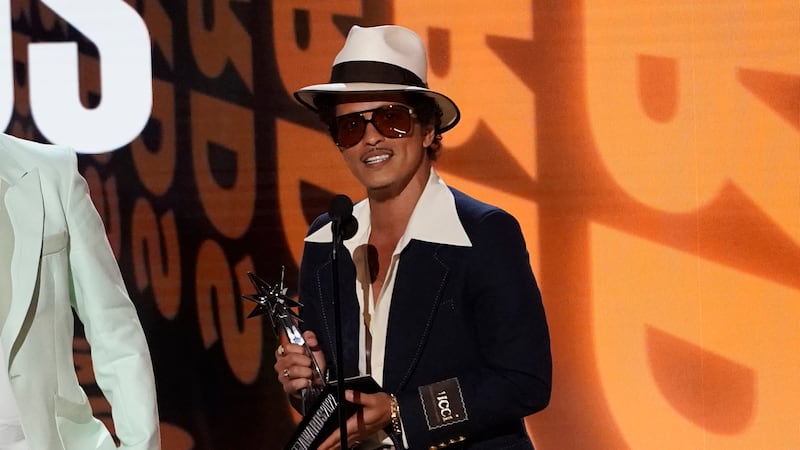 Bruno Mars accepts the award for album of the year for "An Evening with Silk Sonic" at the BET...