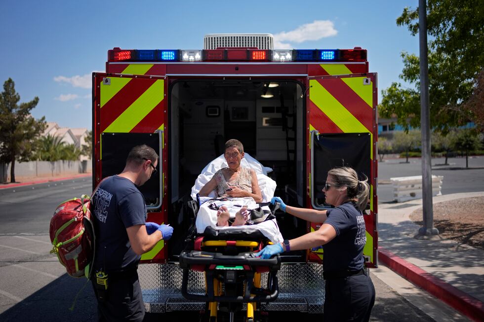 Members of the Henderson Fire Department load Deb Billet, 66, into an ambulance before...