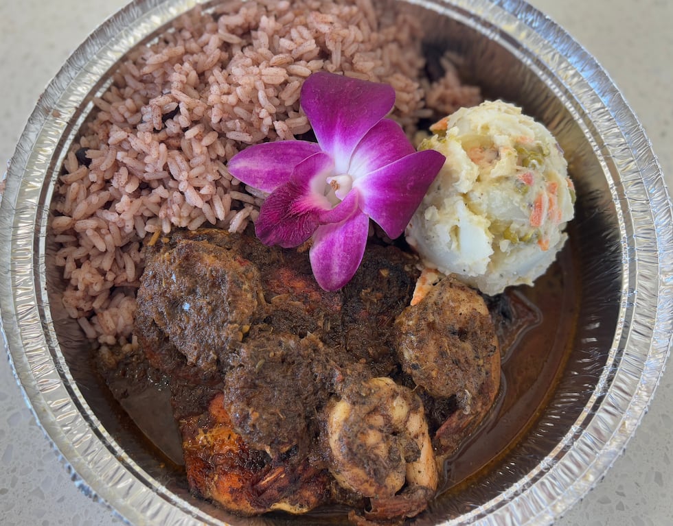 Jerk Seafood Combo Entree (salmon and shrimp) served with rice and peas. Potato salad...