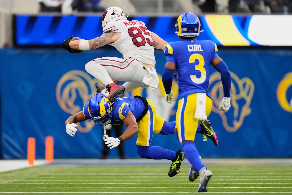 Arizona Cardinals tight end Trey McBride (85) hurdles over Los Angeles Rams cornerback Ahkello...