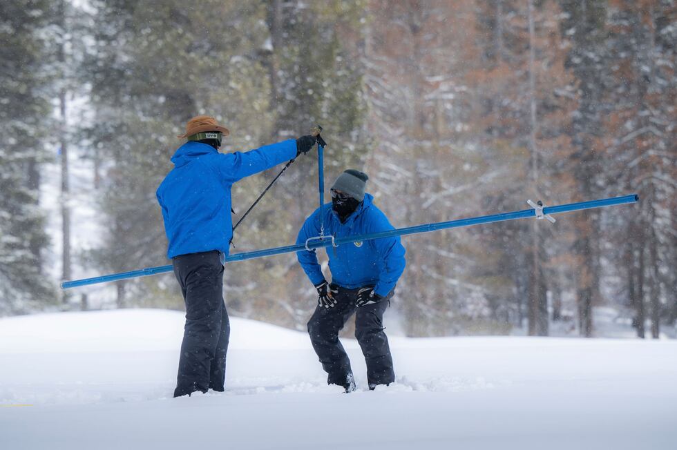 FILE - Sean de Guzman, right, snow survey manager for the Department of Water Resources,...