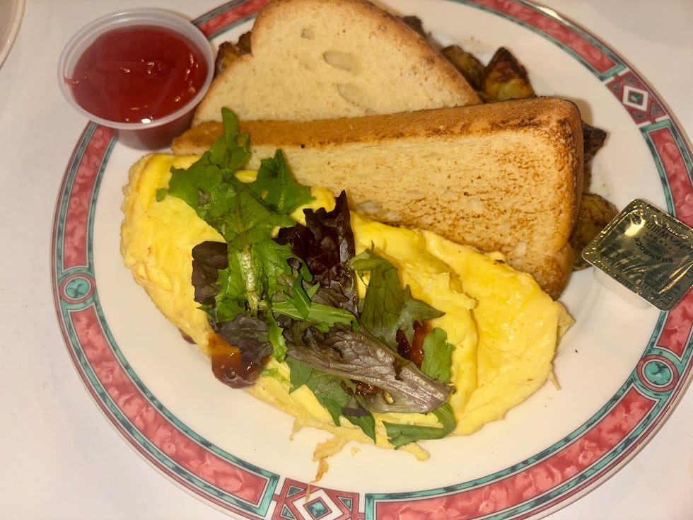 The proscuitto and brie omelette is served with fig jam, potatoes and a choice of toast
