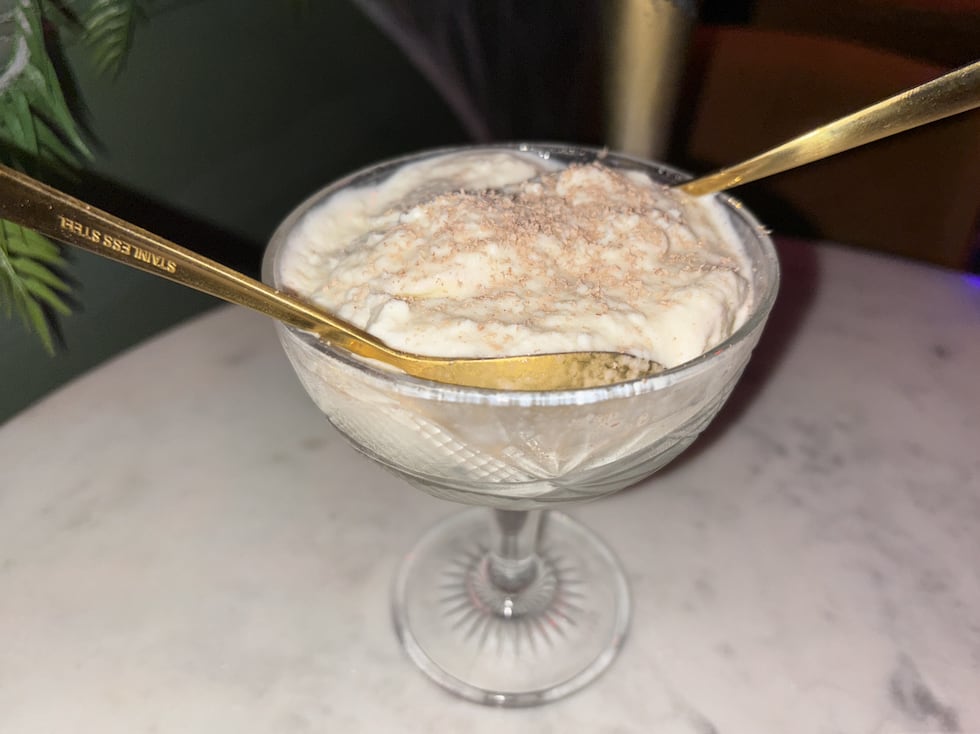 36 Below's seasonal dessert is a coconut sorbet served with chocolate shavings .