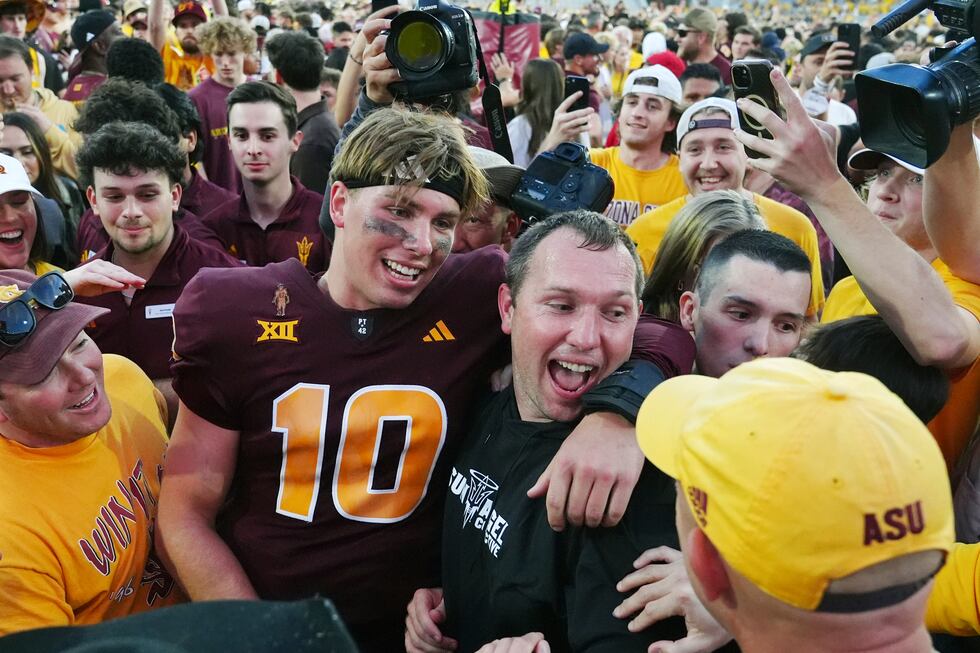Arizona State quarterback Sam Leavitt, left, celebrates a 28-23 win over BYU with head coach...