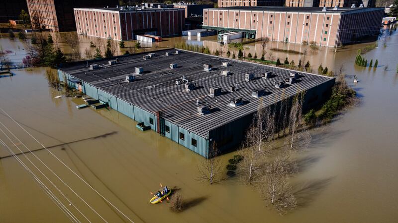 FILE - Kayakers paddle on the floodwaters at the Buffalo Trace Distillery on Monday, April 7,...
