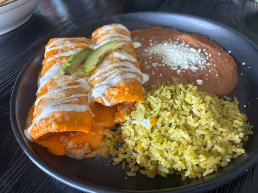 The shrimp enchiladas are two rolled enchiladas in corn tortillas with a red bell pepper...