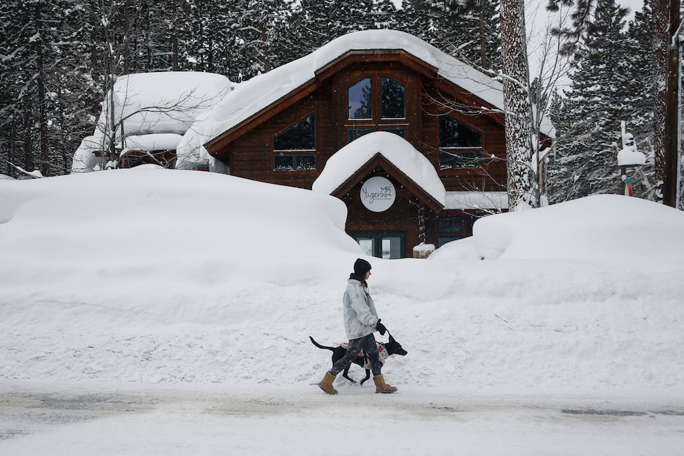 FILE - Laurene Bishop, from South Lake Tahoe, walks her dog Aubrey down Ski Run Boulevard in...